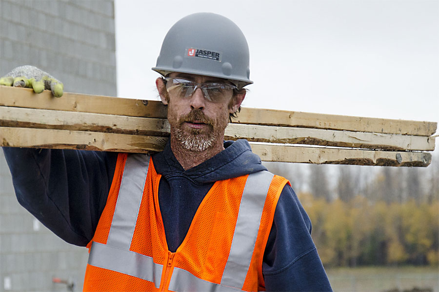 jasper constructors employee holding lumber